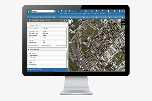 SmartParcels assessed values and transaction history on a monitor.