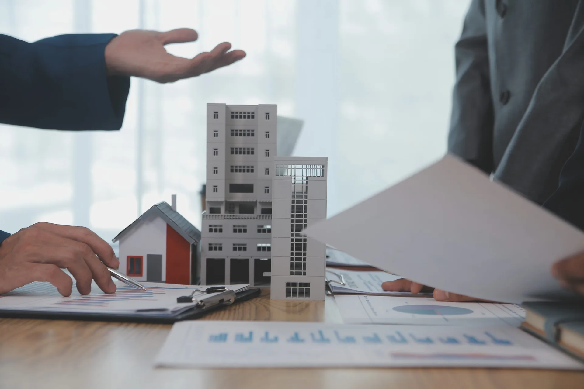 Financial analyst reviewing commercial real estate appraisal reports and portfolio data on a desk